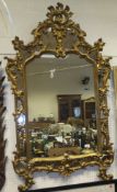 A gilt framed multi-panelled mirror with all-over acanthus leaf moulding decoration