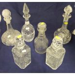 A collection of 19th Century and later cut glass and other decanters,