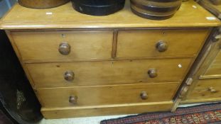 A pine chest of drawers, the plain top above two short and two long drawers,