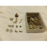 A collection of gold and yellow metal jewellery to include a seal pendant, various earrings,