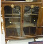 A reproduction burr walnut veneered two door display cabinet