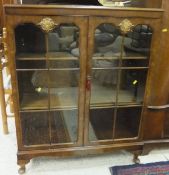 A reproduction burr walnut veneered two door display cabinet