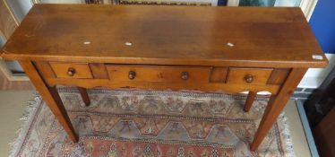 A Chalon fruitwood side table, the plain top above three drawers to a shaped apron,