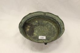 An early Chinese three footed copper bowl with central air dragon decoration