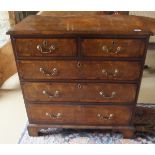 An walnut oyster veneered chest of two short and three long graduated drawers in the George I style,