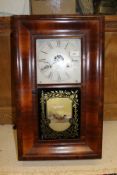 An American walnut cased wall clock of rectangular form,