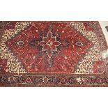 A Caucasian carpet, the central medallion in burgundy, cream and dark blue,