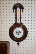 A circa 1900 aneroid barometer thermometer in carved Gothic style frame