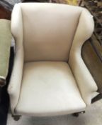 A button back tub chair with cream ground patterned upholstery,