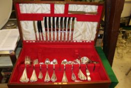 A teak cutlery canteen containing a collection of assorted plated cutlery