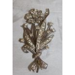 An 18ct white gold and diamond brooch as a floral spray