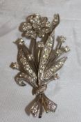 An 18ct white gold and diamond brooch as a floral spray