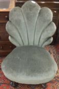 A Victorian nursing chair in sea green upholstery with shell shaped back,