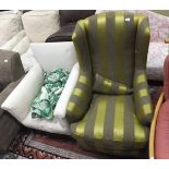 A wing back armchair in lime green and olive green striped upholstery,