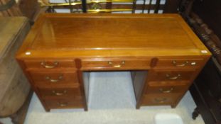 A modern Chinese hardwood pedestal desk, the plain top above a row of three drawers,