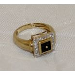 A gold mounted square set dress ring with four central sapphires within a band of illusion set