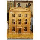 A plywood three-storey doll's house (un-painted)