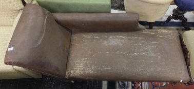 A Victorian chaise longue upholstered in brown rexine fabric,