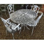 A white painted metal garden table and set of four chairs