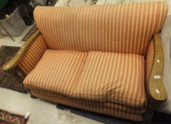 An early 20th Century two seat sofa with barley-twist oak show frame,