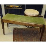 A mahogany duet stool with green velvet upholstery, raised on square tapering legs,