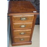 A pair of walnut bedside chests of four graduated drawers,