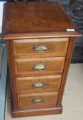 A pair of walnut bedside chests of four graduated drawers,