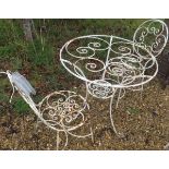 A white painted wirework garden table and two chairs