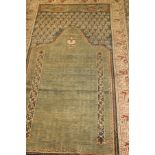 A fine Turkish prayer rug, the central Mirhab in greens and terracotta, within cream, terracotta,