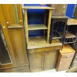 A pine cupboard with single drawer above two cupboard doors, raised on a plinth base,