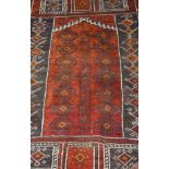 A Caucasian prayer rug, the terracotta ground with repeating medallions in madder and amber,