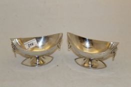 A pair of George V silver boat shaped open sweetmeat dishes with gadrooned rims and lion mask ring