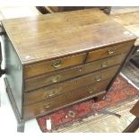 An oak chest of two short over three long graduated drawers with brass handles,