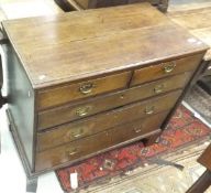 An oak chest of two short over three long graduated drawers with brass handles,