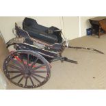 A Governess cart with black painted body and mud guards, with black leatherette upholstered seats,