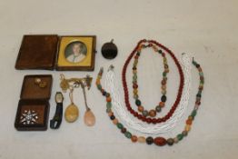 A box containing a collection of jewellery and decorative items to include a pair of white metal