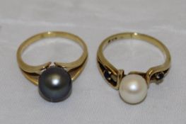 An 18ct gold black pearl (dyed) solitare dress ring, the pearl approx 8mm diameter, size N ,