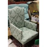 A 19th Century Victorian armchair upholstered in green damask