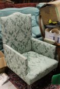 A 19th Century Victorian armchair upholstered in green damask