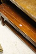 A mahogany coffee table with single drawer,