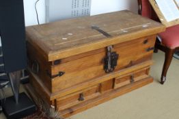 A pine trunk with metal mounts, the rectangular top above two drawers,