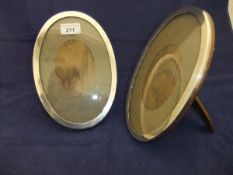 A pair of George V oval silver and oak photograph frames with easel back (by Sanders & Mackenzie -