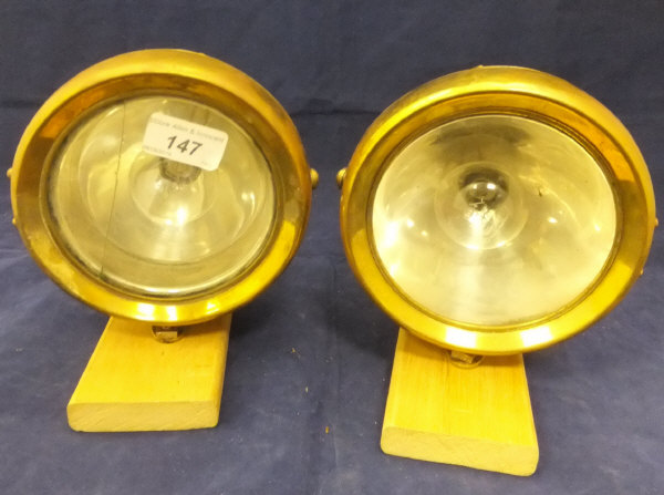 A collection of various lamps to include two Brolt lighting system head lamps, two radiator lamps,