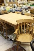 A modern rectangular farmhouse style kitchen table and a set of six beech and elm stick back