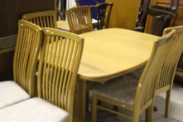 A Danish oak dining room suite comprising six slatted dining chairs, dining table,