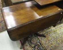 A 19th Century mahogany Pembroke table with single end drawer on turned and ringed central pedestal