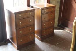 A pair of burr oak and crossbanded bedside chests of four drawers,