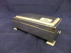 A 20th Century silver sheathed cigarette box with cedar lining on splayed bracket feet (marks