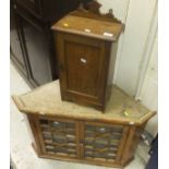 A small oak cupboard with single panelled door opening to reveal single shelf and a 19th Century