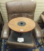 An Ekornes style stressless brown leather armchair and footstool